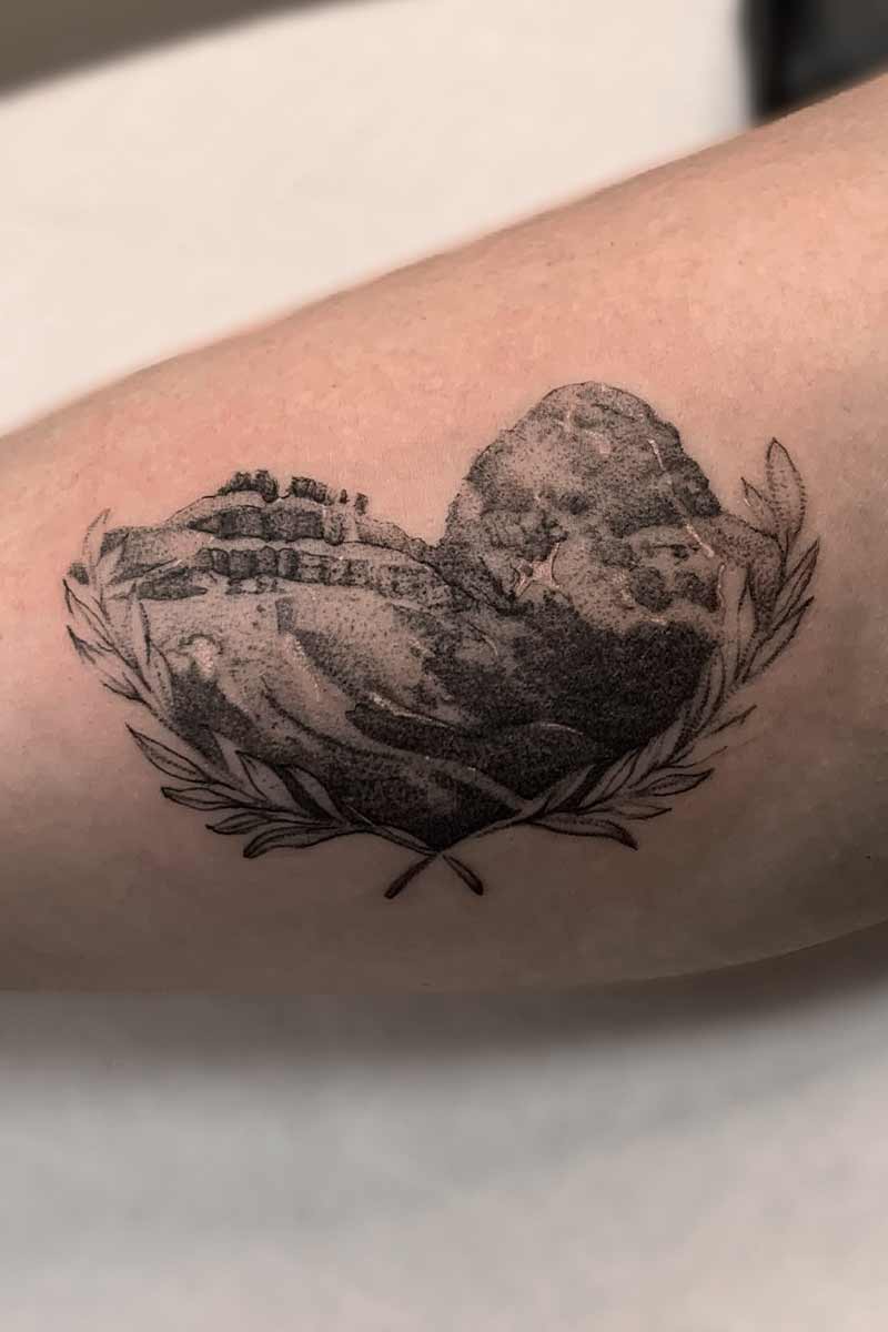Legacy Tattoo| Walk-in Tattoo| Black and grey, realism tattoo of a mountain, framed in a heart and leaves