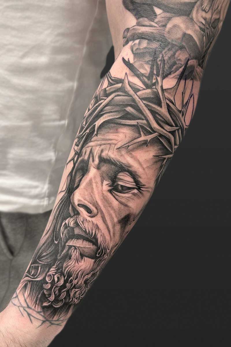 Legacy Tattoo| Black and grey, realism tattoo of Jesus wearing a crown of thorns