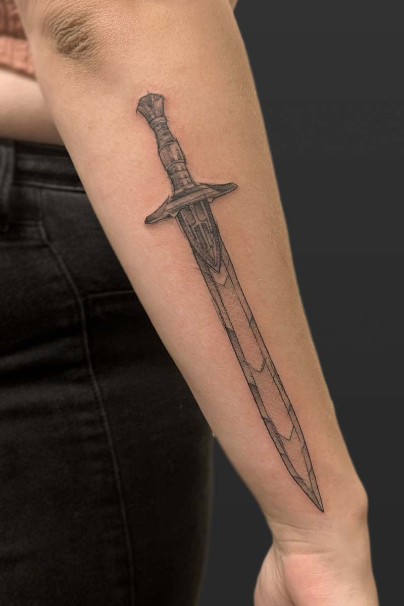 Legacy Tattoo| Black and grey, illustrative tattoo of a sword