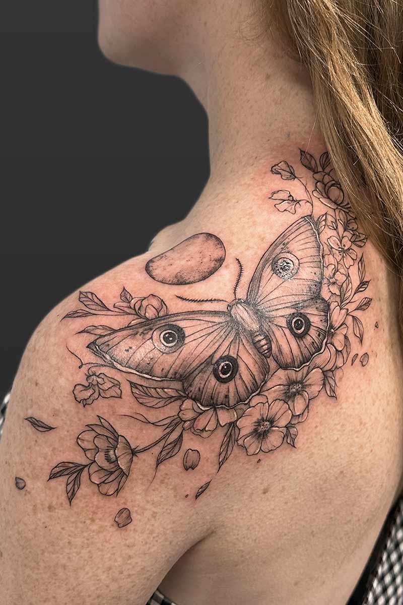 Legacy Tattoo| Black and grey tattoo of a moth, flowers and moon