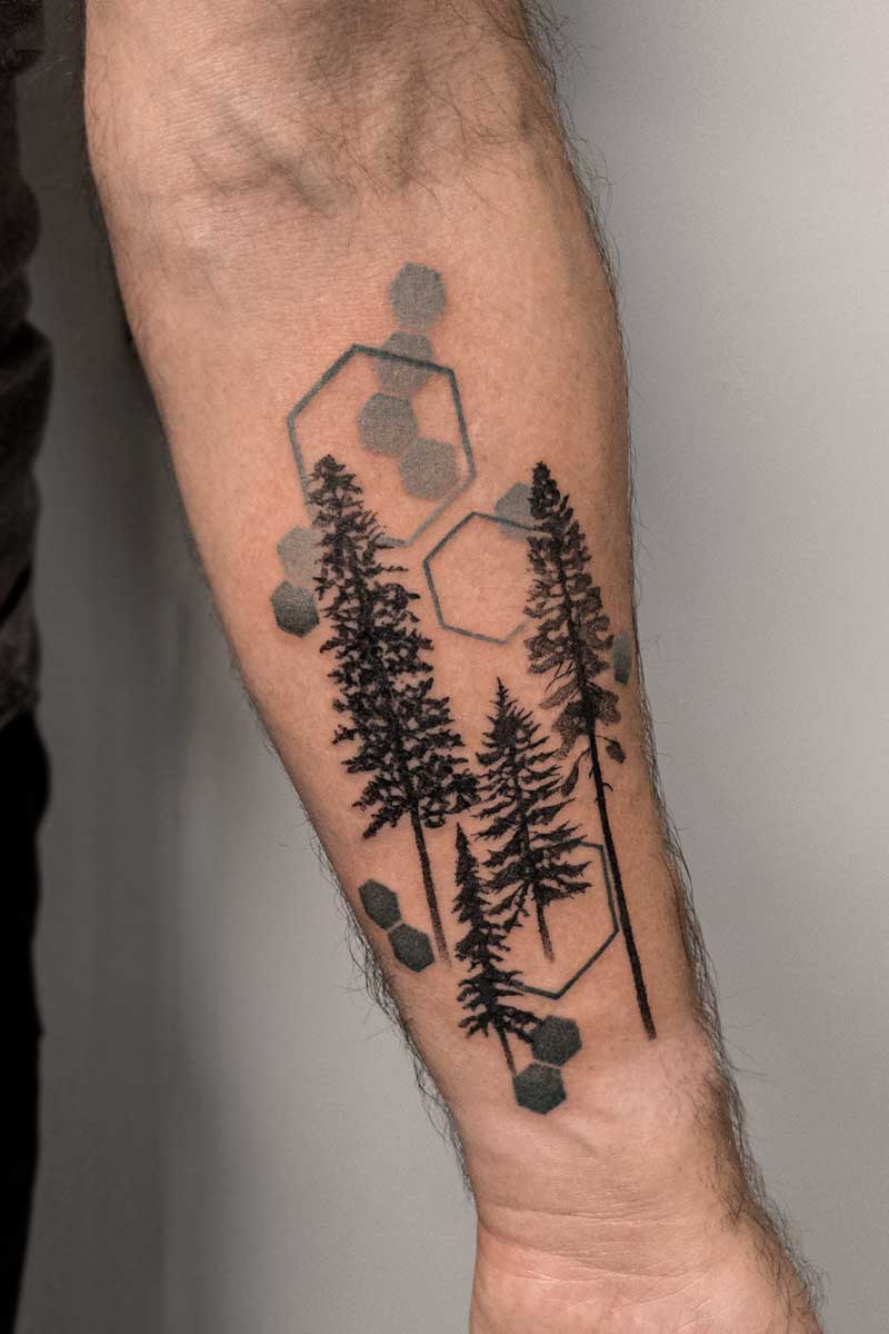 Legacy Tattoo| Black and grey, realism tattoo of pine trees and hexagons behind them