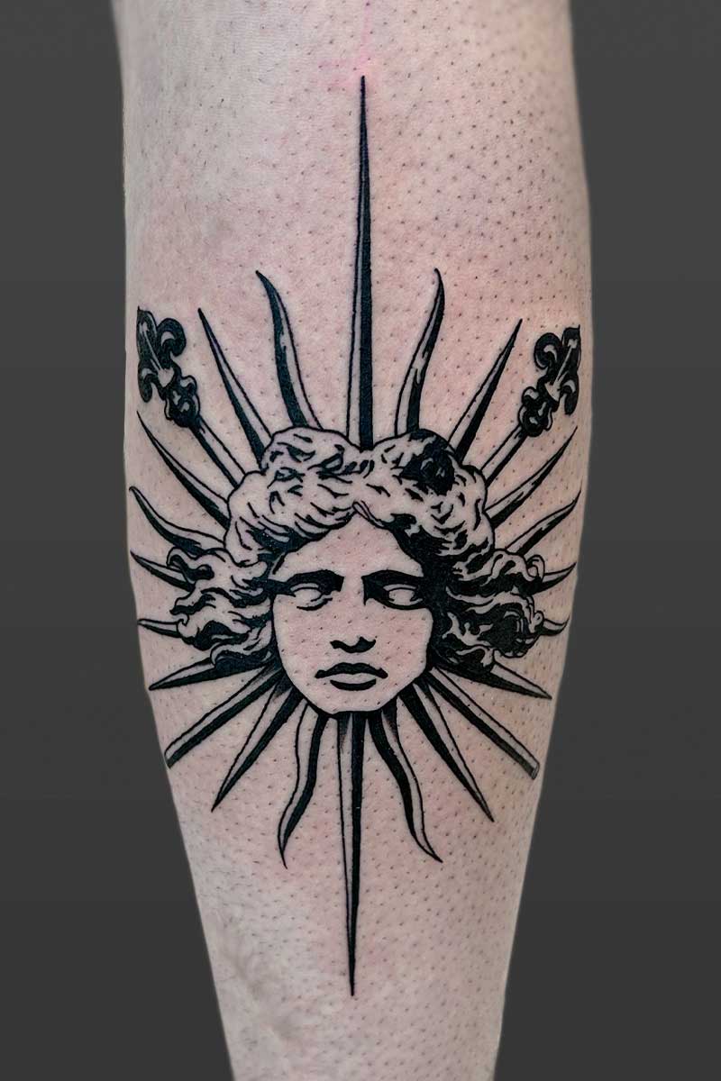 Legacy Tattoo| Blackwork tattoo of an ornamental sun with a face