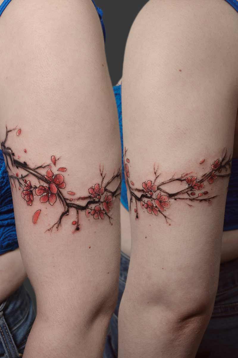 Legacy Tattoo| Watercolour tattoo of a branch of cherry blossoms around the client's arm
