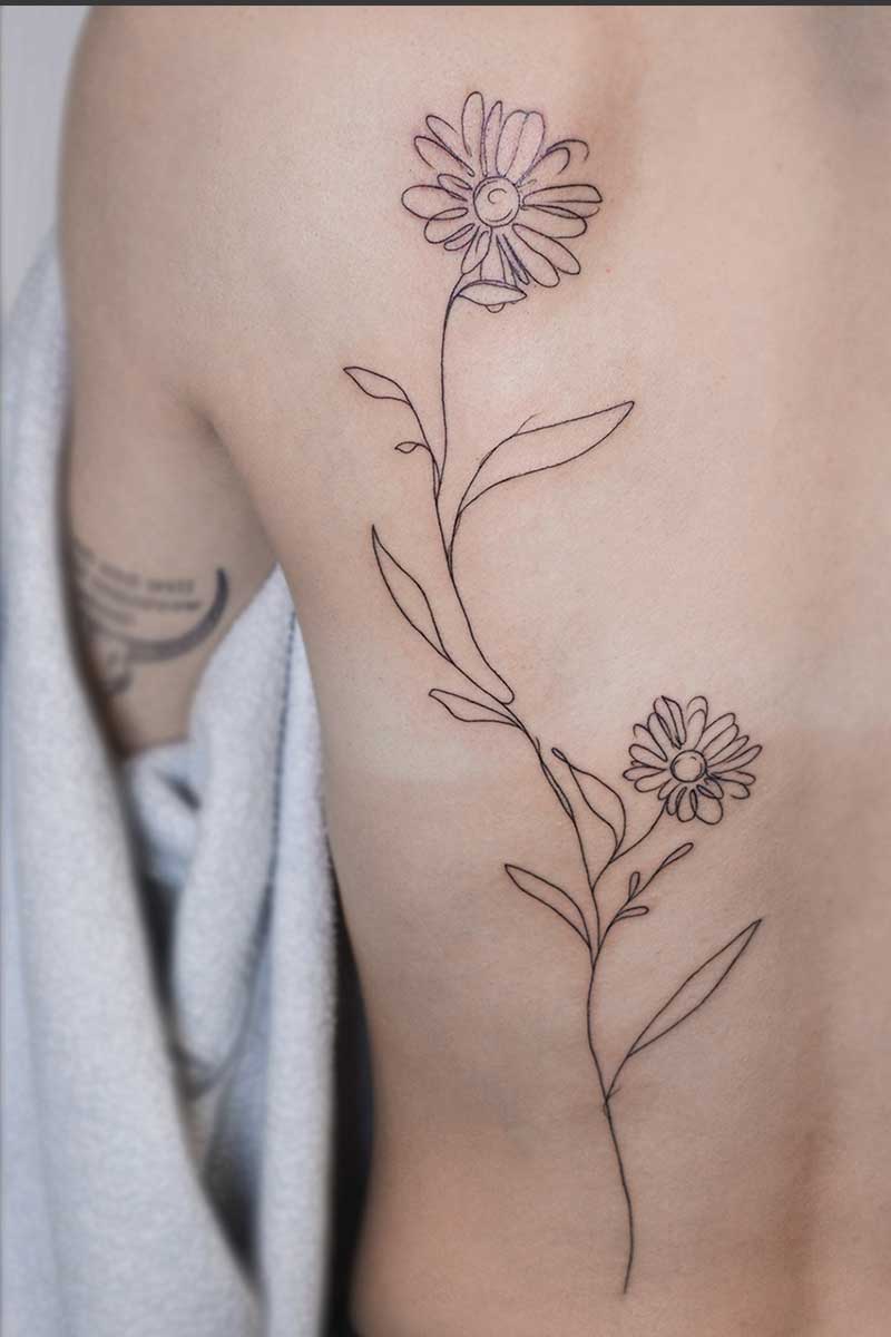 Legacy Tattoo| Fineline, back tattoo of simple, abstract daisies