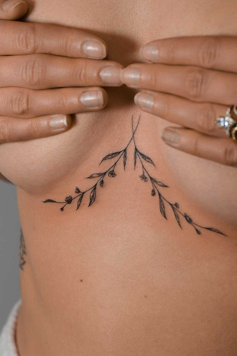 Legacy Tattoo| Walk-in Tattoo| Fineline tattoo of two stems of leaves and small flowers