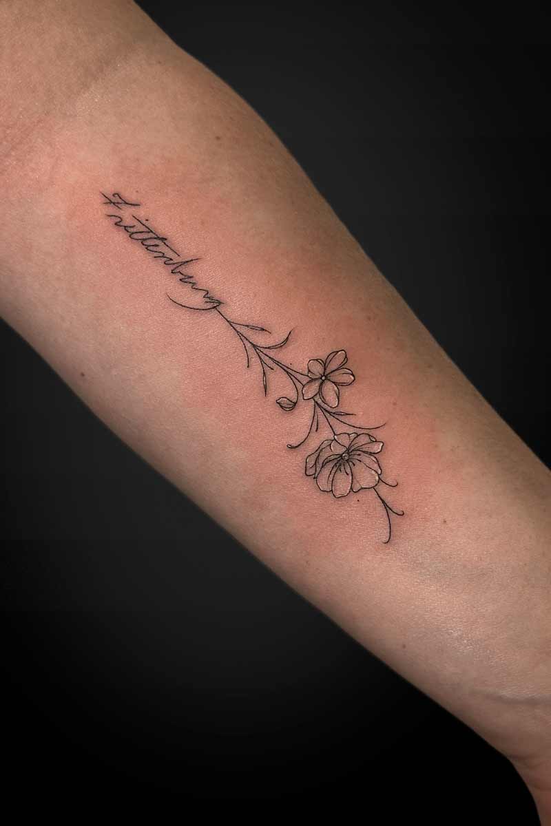 Legacy Tattoo| Fineline tattoo of flowers and a name