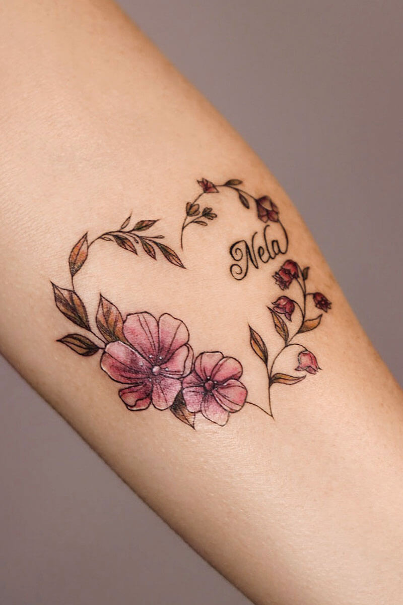 Legacy Tattoo| Fineline tattoo of pink flowers in the shape of a heart