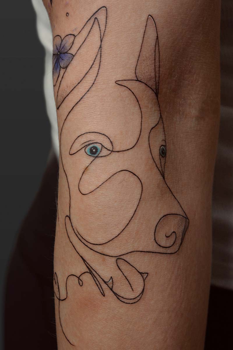 Legacy Tattoo| Fineline tattoo of the outline of a husky dog