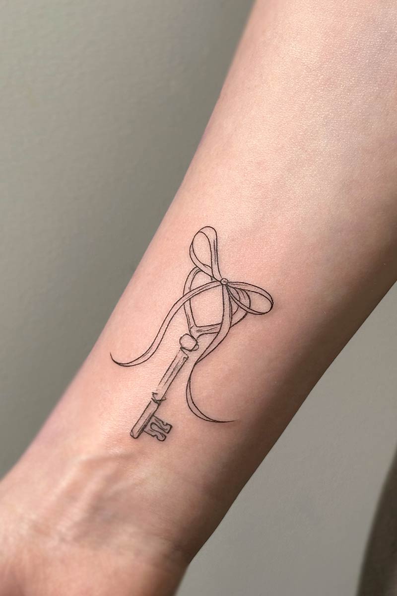 Legacy Tattoo| Walk-in Tattoo| Fineline tattoo of a key and ribbon