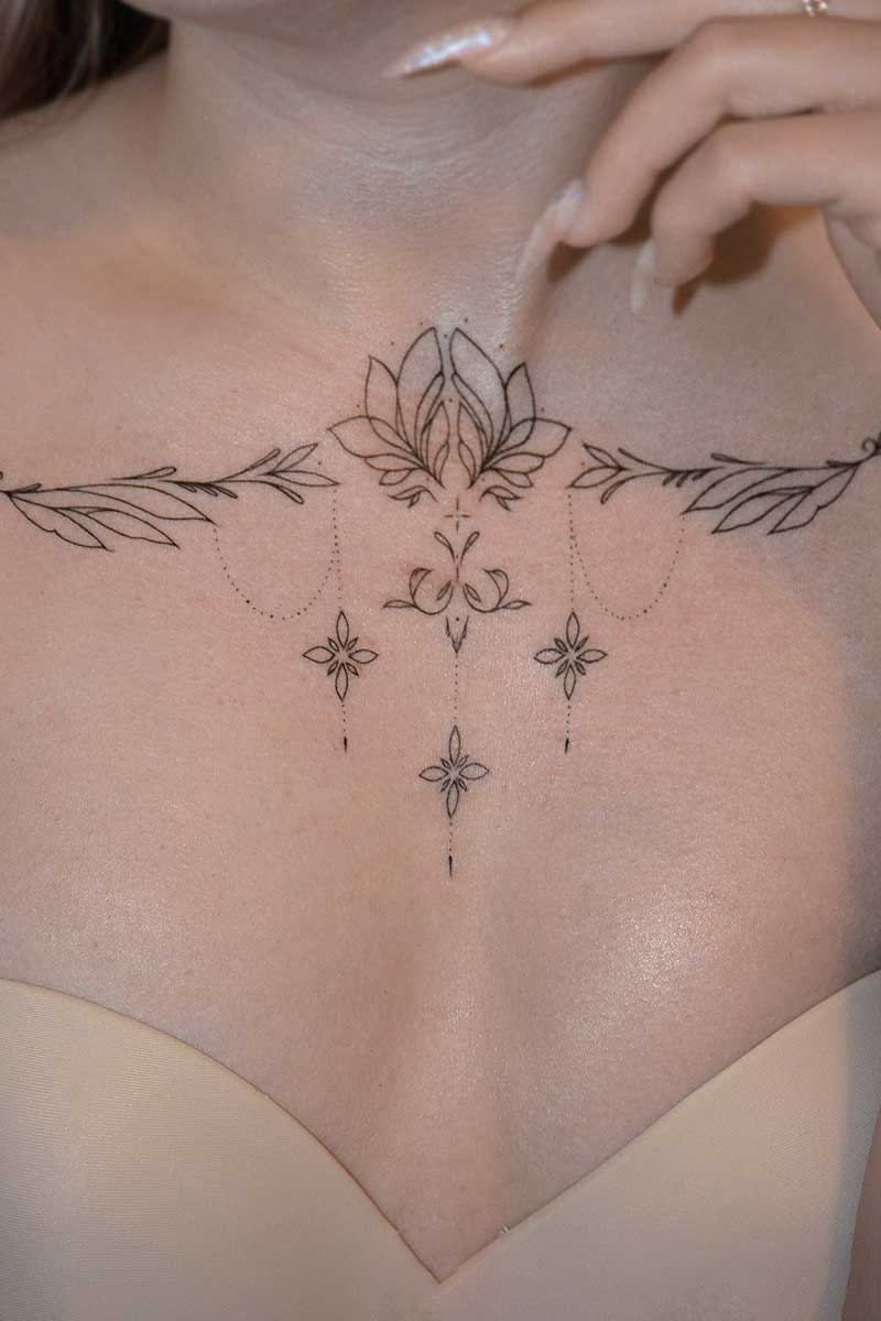 Legacy Tattoo| Fineline tattoo of ornamental elements on the client's collarbones