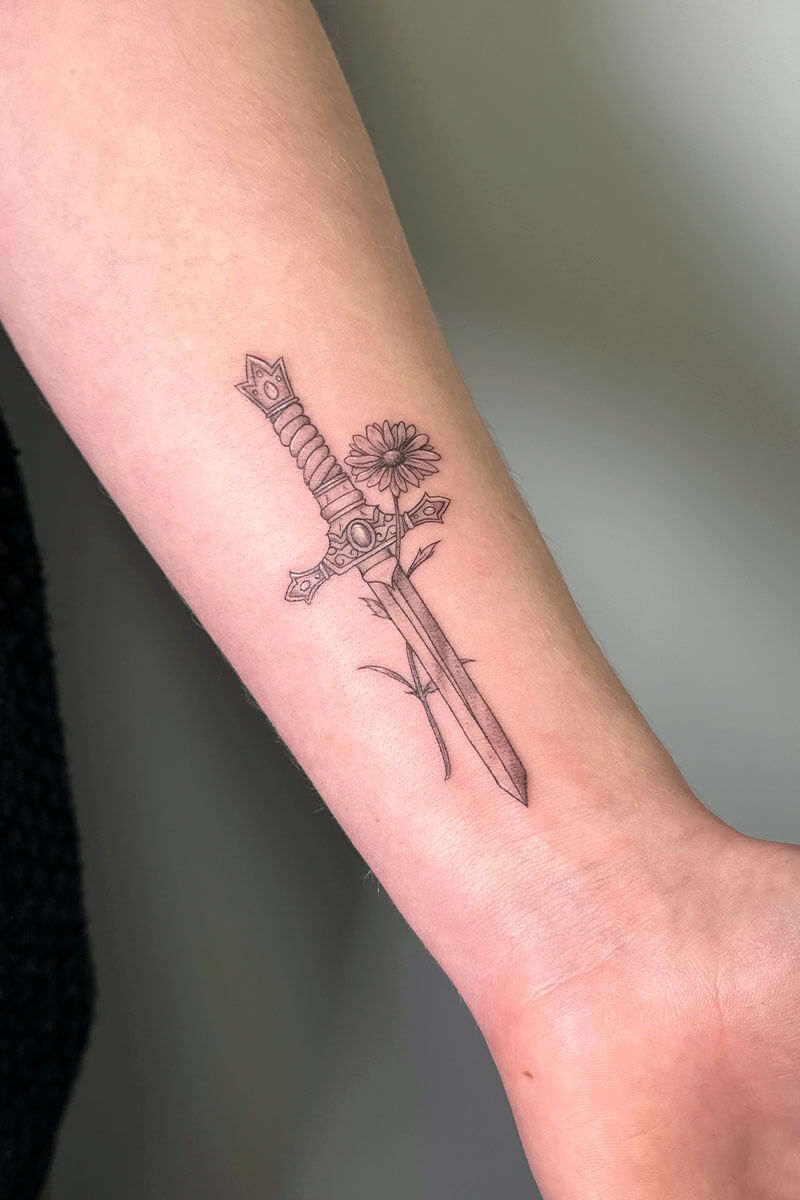 Legacy Tattoo| Fineline tattoo of a decorated dagger and flower