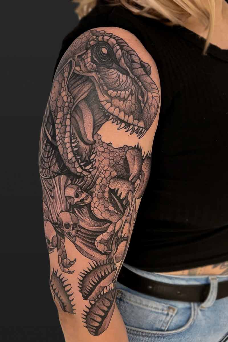 Legacy Tattoo| Neotraditional tattoo of a t-rex, wearing a necklace of skulls and venus fly traps in front of it