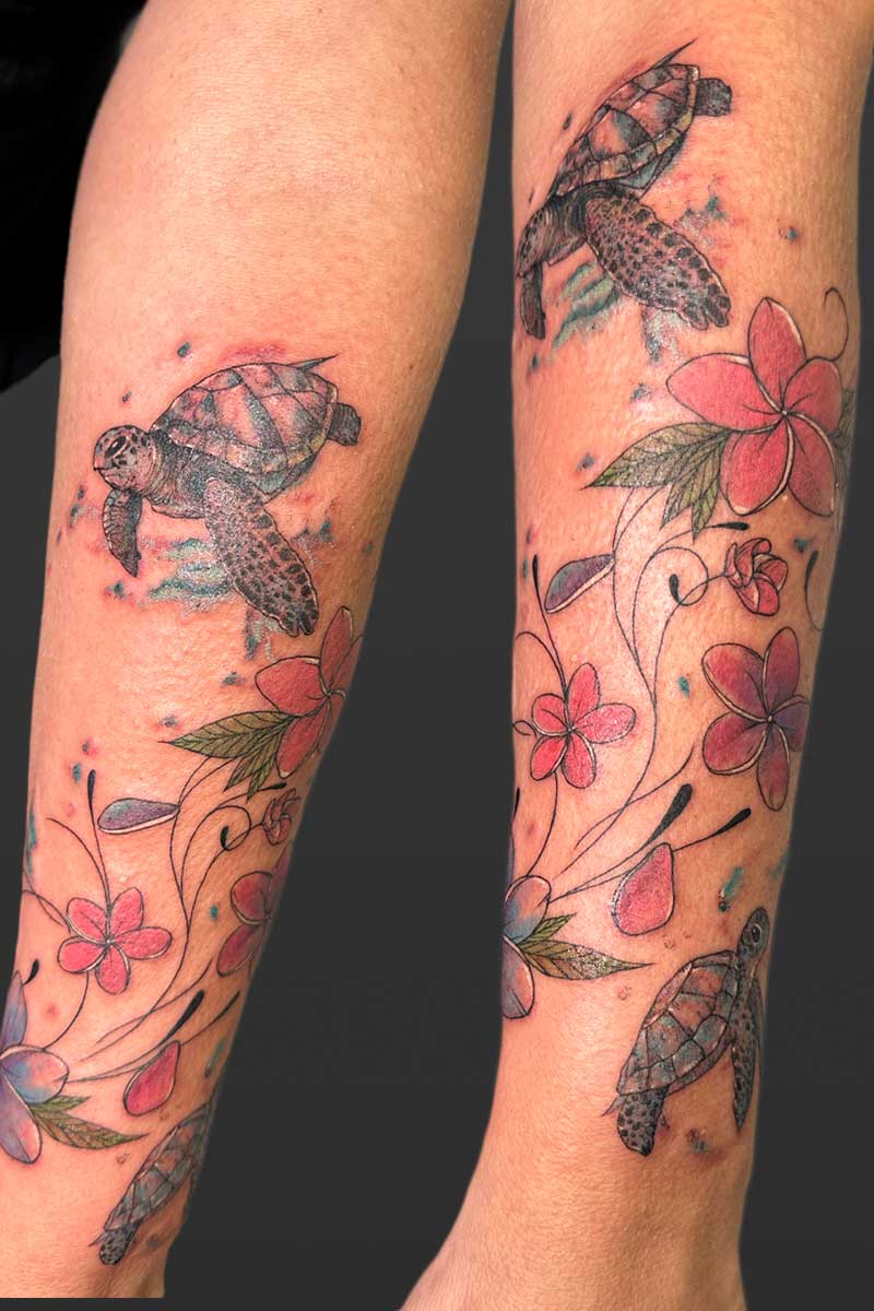 Legacy Tattoo| Realism tattoo of sea turtles with splashes of watercolours and vines of pink flowers