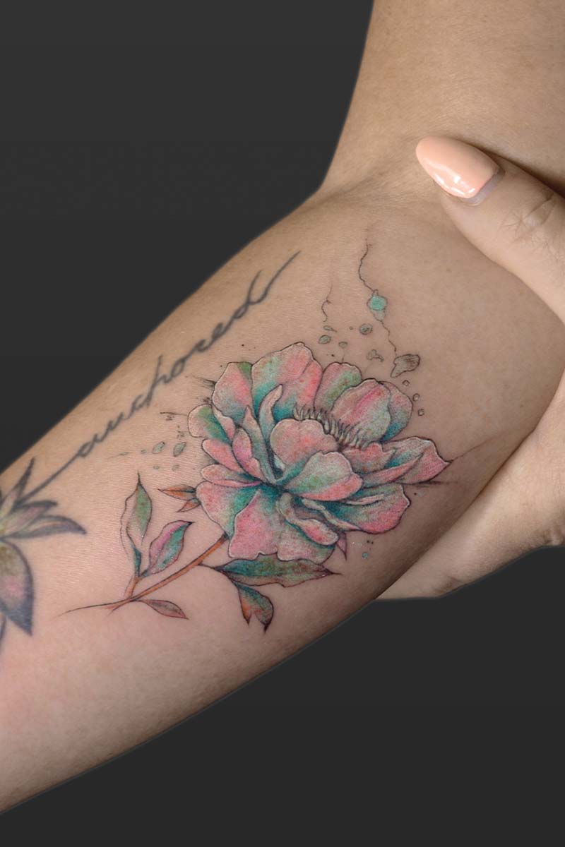Legacy Tattoo| Fineline, watercolour tattoo of a pink and blue peony