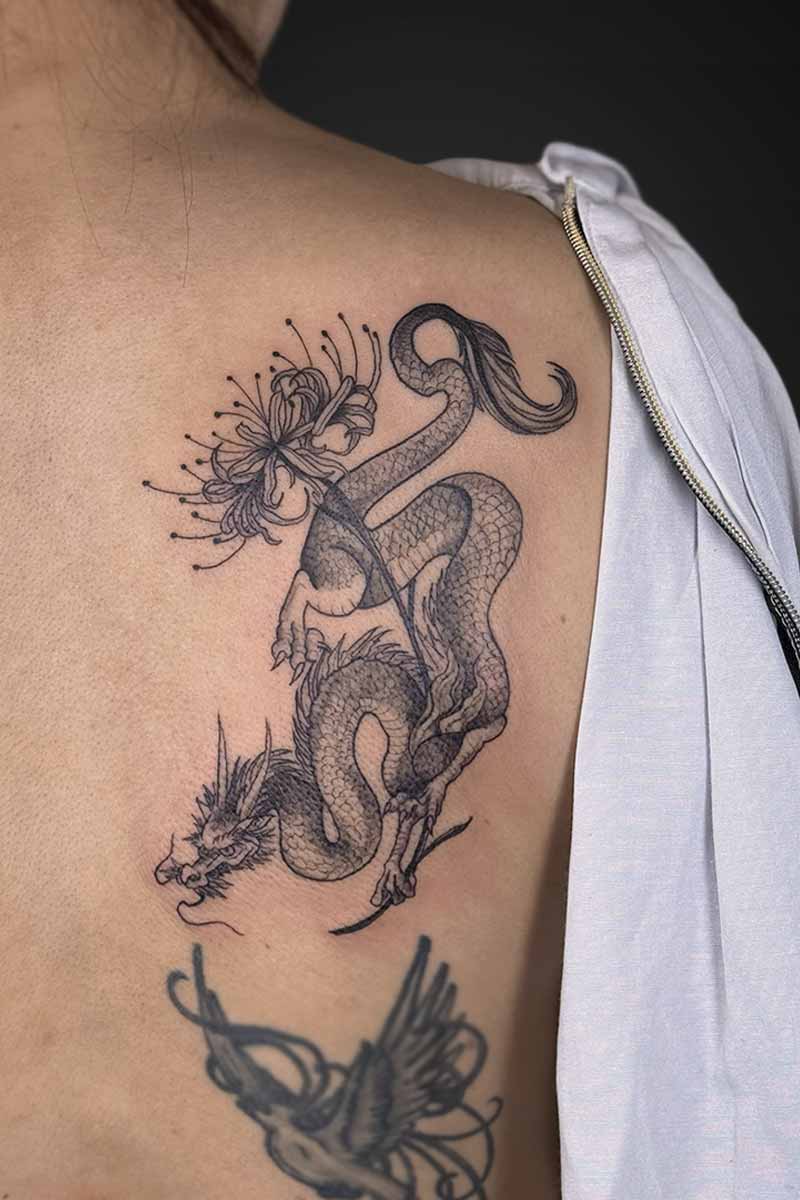 Legacy Tattoo| Black and grey tattoo of a Japanese dragon and Japanese spider lily