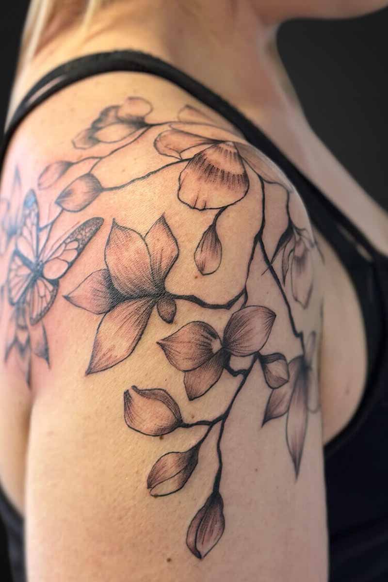Legacy Tattoo| Black and grey tattoo of a floral branch
