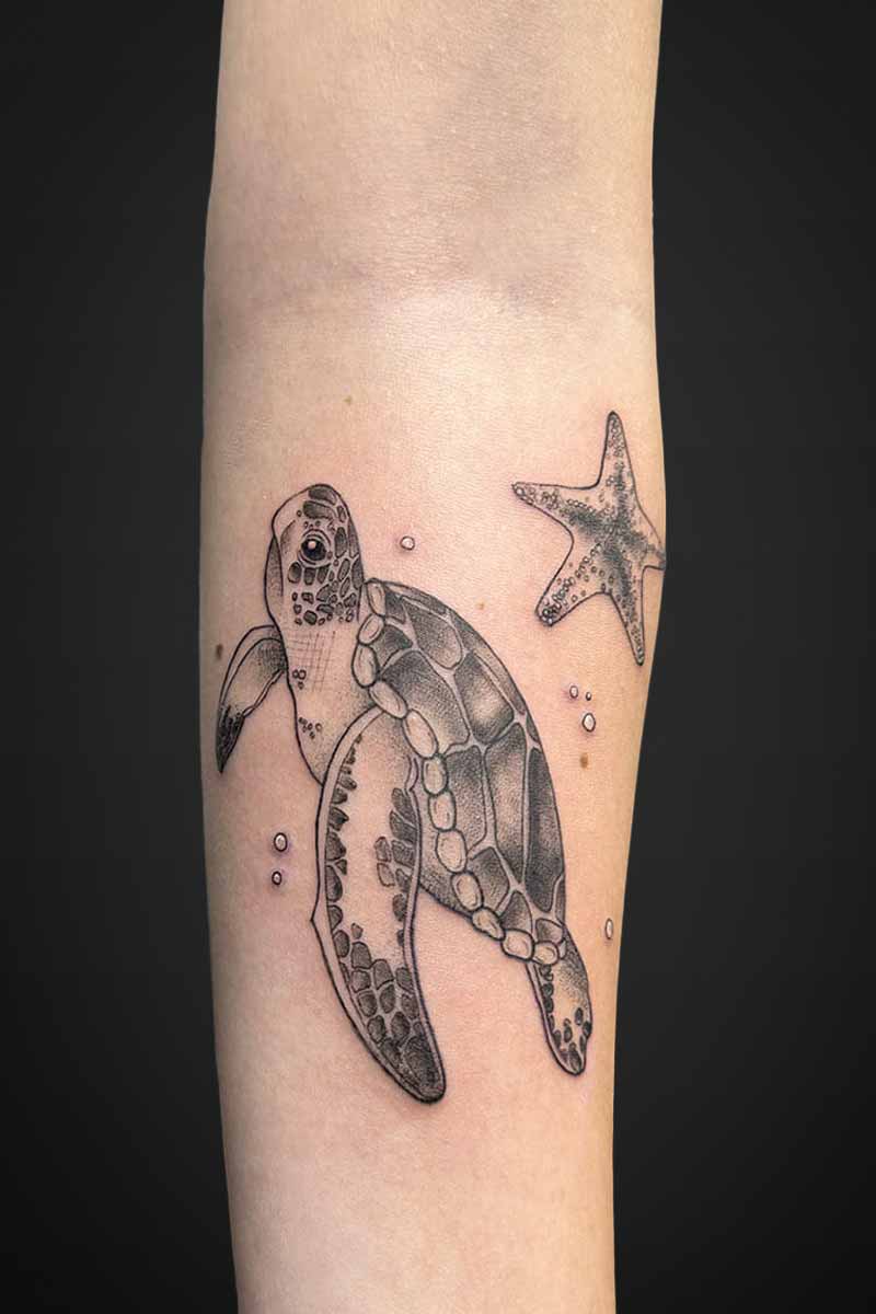 Legacy Tattoo| Black and grey tattoo of a sea turtle and a starfish