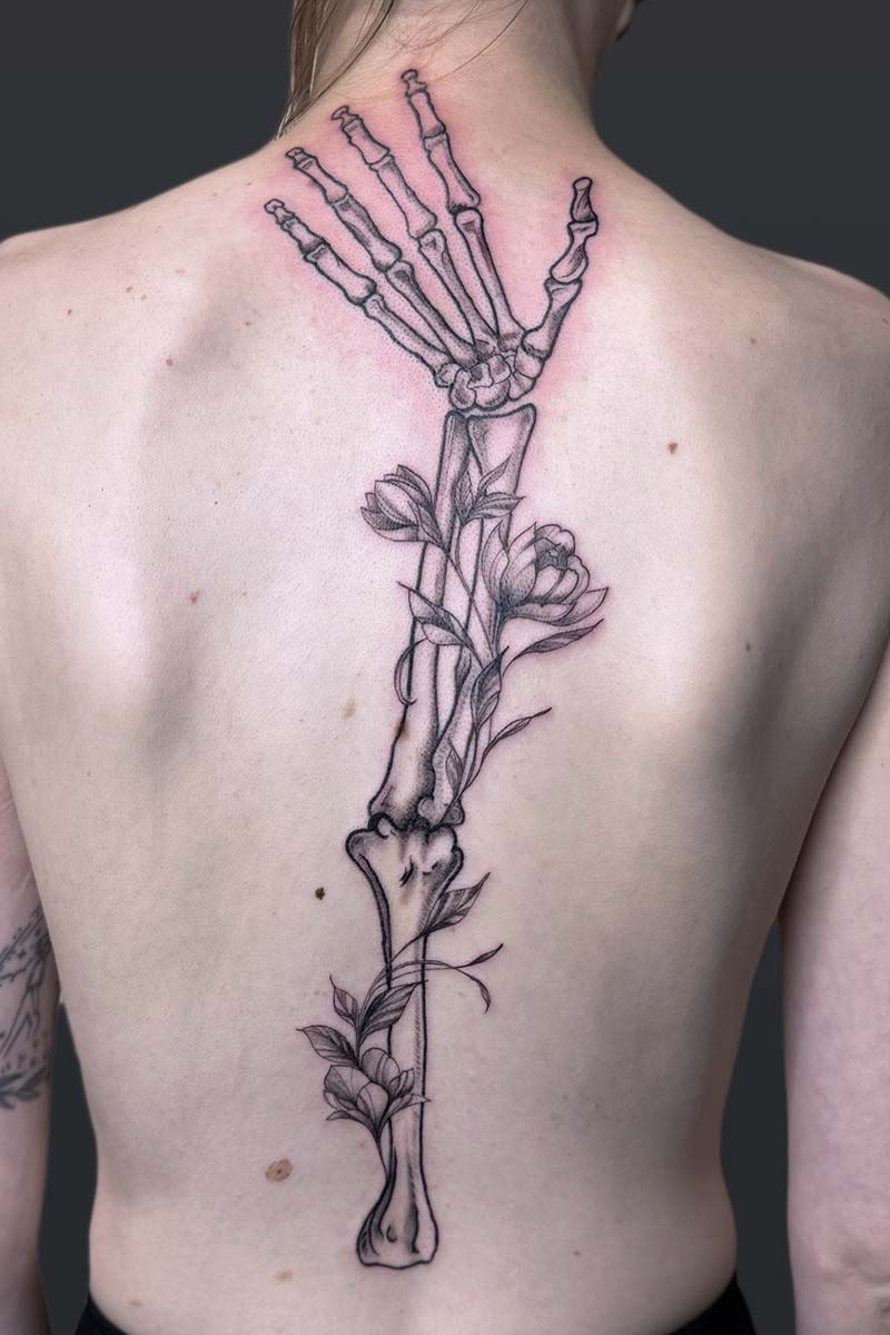 Legacy Tattoo| Neotraditional tattoo of a skeleton arm with florals
