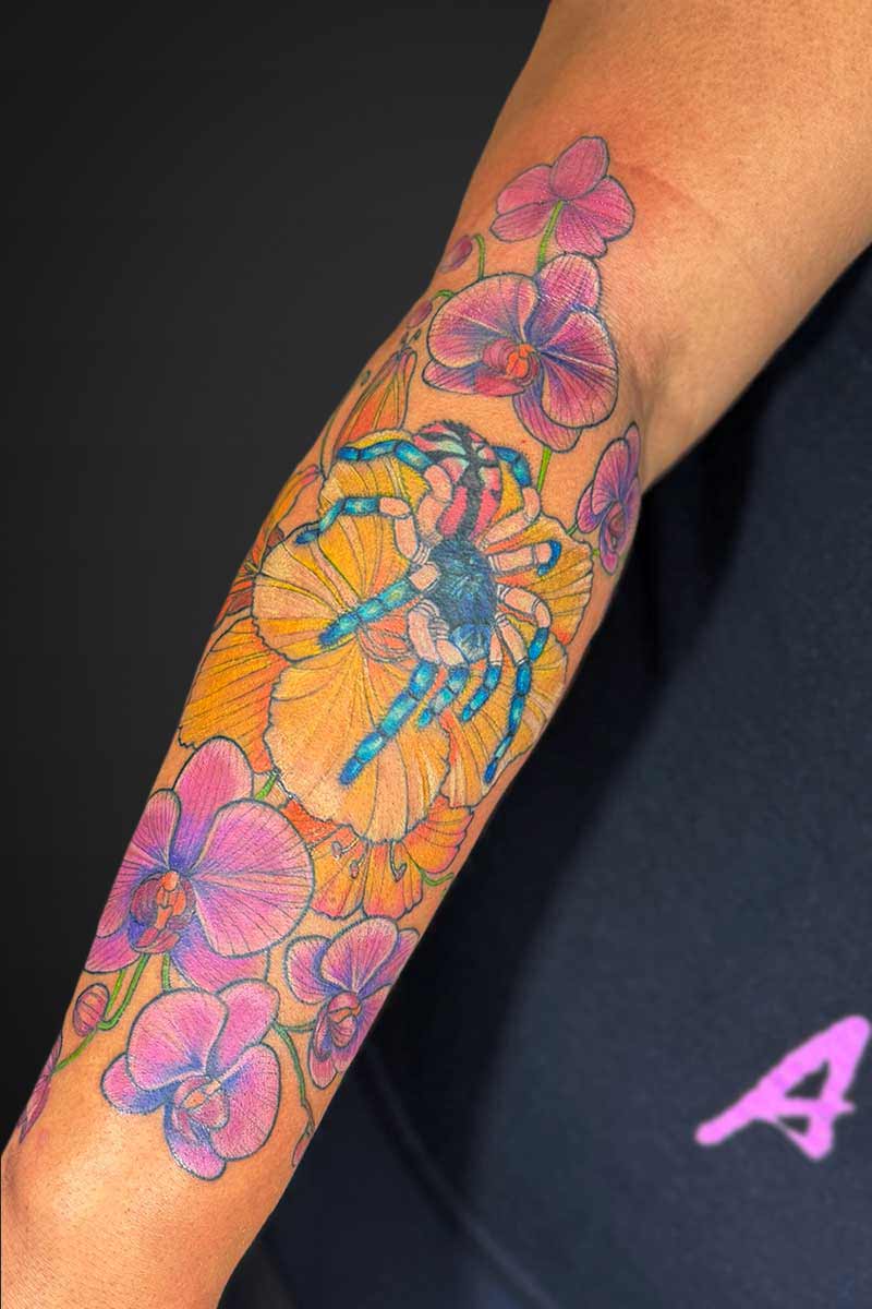 Legacy Tattoo| Neotraditional, floral tattoo of pink orchids, yellow hibiscus flower and a colourful tarantula