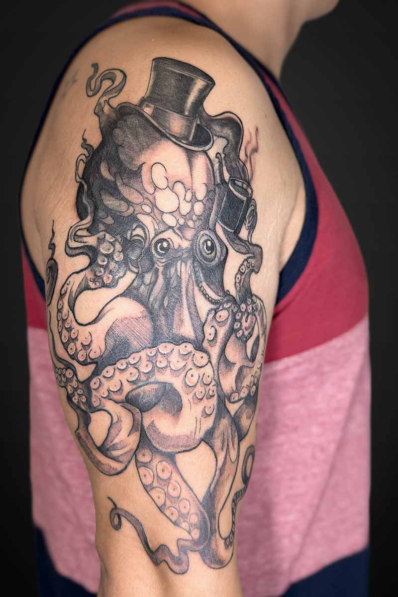 Legacy Tattoo| Coverup tattoo of an octopus wearing a top hat