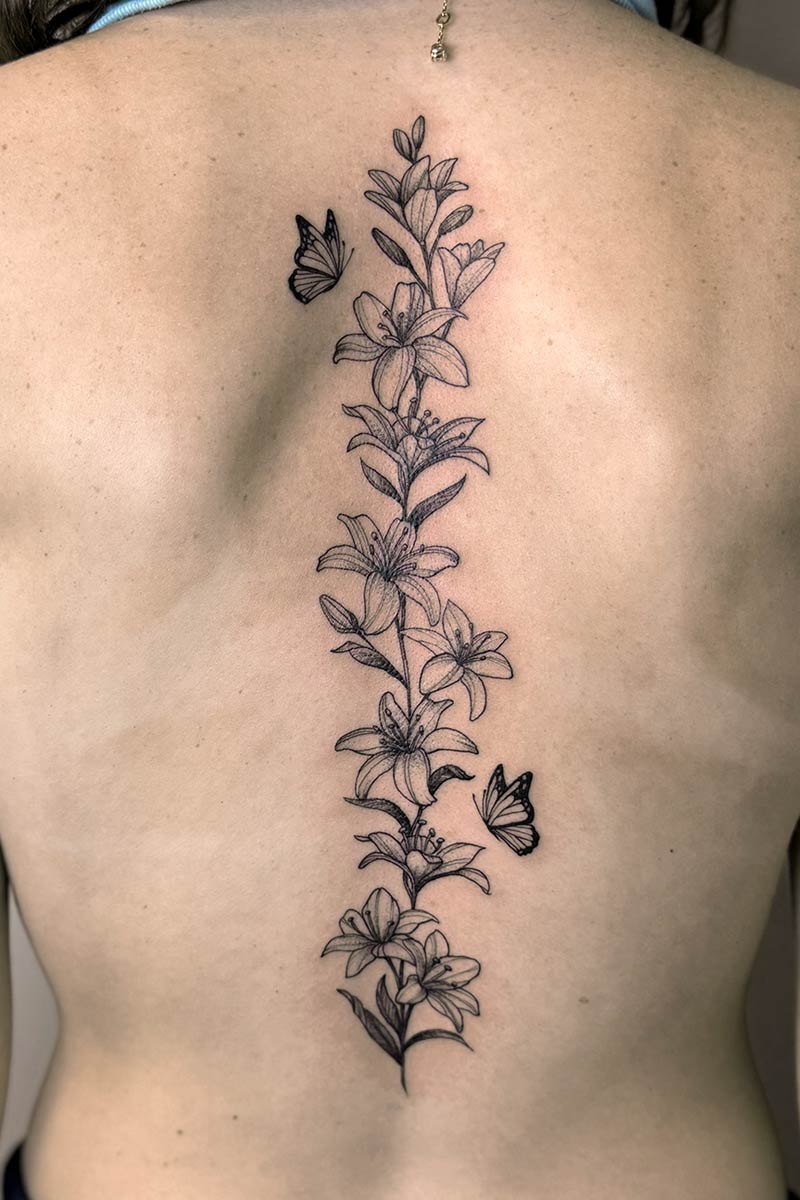 Legacy Tattoo| Fineline, floral tattoo of lilys and butterflies