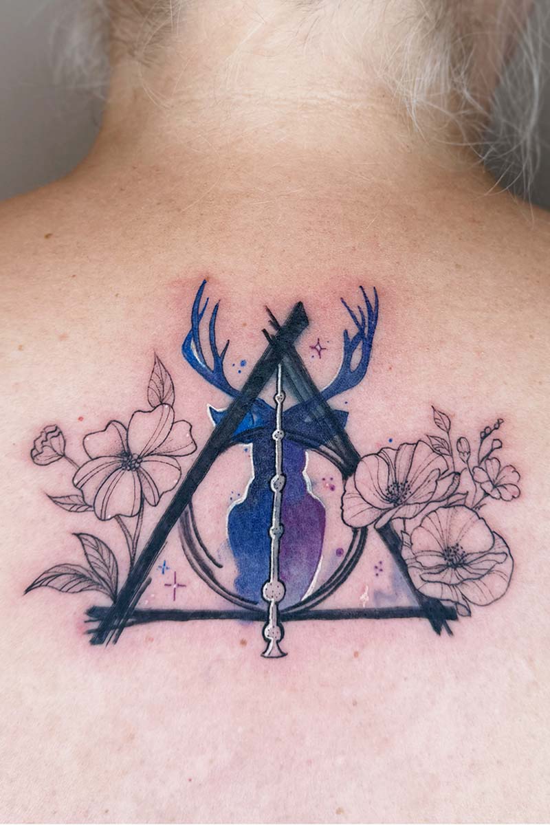 Legacy Tattoo| Coverup tattoo of imagery from Harry Potter with flowers