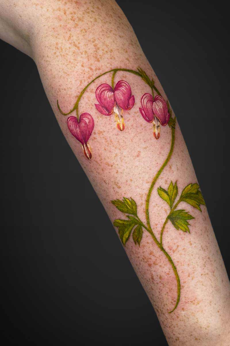 Legacy Tattoo| Realism floral tattoo of pink bleeding heart flowers