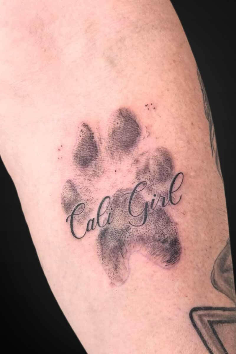 Legacy Tattoo| Microrealism tattoo of a paw print and name "Cali Girl"